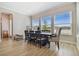 Well-lit dining room with large windows, wood-look tile, and seating for eight at 6129 Marsh Trail Dr, Odessa, FL 33556