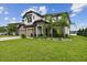 Beautiful two-story home with a well-manicured lawn, three-car garage, and tasteful stone accents at 6129 Marsh Trail Dr, Odessa, FL 33556