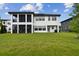 Spacious home exterior featuring a well-manicured lawn and covered patio at 6129 Marsh Trail Dr, Odessa, FL 33556