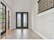 A grand entrance with high ceilings, wood-look tile flooring and a beautiful double front door at 6129 Marsh Trail Dr, Odessa, FL 33556