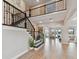 Grand foyer features a staircase with dark wood banisters and an open view to the formal sitting room at 6129 Marsh Trail Dr, Odessa, FL 33556