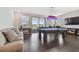 A spacious game room featuring a pool table, comfortable seating, and lots of natural light at 6129 Marsh Trail Dr, Odessa, FL 33556