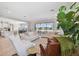 Spacious living room with modern furnishings, a large sliding glass door and a view to the kitchen at 6129 Marsh Trail Dr, Odessa, FL 33556