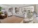 Open-concept living room with views to the dining and kitchen areas, perfect for entertaining at 6129 Marsh Trail Dr, Odessa, FL 33556