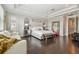 Spacious primary bedroom featuring hardwood floors, a sitting area, and lots of natural light at 6129 Marsh Trail Dr, Odessa, FL 33556