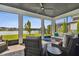 Relaxing screened patio with lake views, comfortable seating, and a cozy ambiance at 6129 Marsh Trail Dr, Odessa, FL 33556