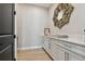 Bright room with white cabinetry, quartz counters, and decorative mirror at 6129 Marsh Trail Dr, Odessa, FL 33556