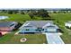 Aerial view of a charming single-story home with a spacious front yard in a tranquil neighborhood at 624 La Jolla Ave, Sun City Center, FL 33573