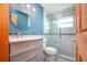 Bathroom featuring tiled shower, toilet, modern vanity, and mirror with stylish finishes at 624 La Jolla Ave, Sun City Center, FL 33573