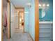 Hallway bathroom featuring modern vanity, mirror, and lighting fixtures with bathroom and bedroom access at 624 La Jolla Ave, Sun City Center, FL 33573