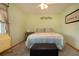 Bedroom with light green walls, window with curtains, and 'Welcome' throw pillows at 624 La Jolla Ave, Sun City Center, FL 33573