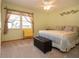 Bedroom with light green walls, large window with curtains and padded bench at 624 La Jolla Ave, Sun City Center, FL 33573