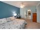 Spacious carpeted bedroom with a desk and sliding glass doors leading to the outdoor area and dining space at 624 La Jolla Ave, Sun City Center, FL 33573