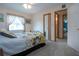 Bedroom with carpet, window and closet with bathroom access, ensuring functionality and comfort at 624 La Jolla Ave, Sun City Center, FL 33573