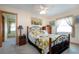 Comfortable bedroom featuring a ceiling fan, light-colored walls, and a decorative bed frame at 624 La Jolla Ave, Sun City Center, FL 33573
