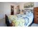 Cozy bedroom with a closet, decorated with colorful flower-patterned sheets at 624 La Jolla Ave, Sun City Center, FL 33573