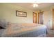 Cozy bedroom with light green walls featuring bed and window with natural light at 624 La Jolla Ave, Sun City Center, FL 33573
