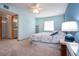 Cozy bedroom featuring carpet, a ceiling fan, and en-suite bathroom access, perfect for relaxation at 624 La Jolla Ave, Sun City Center, FL 33573
