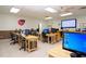 Bright computer room with several desk stations, each equipped with monitors and chairs at 624 La Jolla Ave, Sun City Center, FL 33573