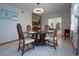 Dining room featuring glass table, seating, decorative lighting, and kitchen access at 624 La Jolla Ave, Sun City Center, FL 33573