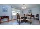 Dining room features a glass table, seating for six, and decorative lighting at 624 La Jolla Ave, Sun City Center, FL 33573