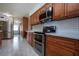 Spacious kitchen with stainless appliances, new cabinets, countertops, and marble floors at 624 La Jolla Ave, Sun City Center, FL 33573
