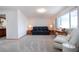 Comfortable living room with neutral carpet, cozy seating, and ample space for entertaining at 624 La Jolla Ave, Sun City Center, FL 33573