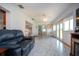 Open living room with marble floors, fireplace, and access to the sunroom at 624 La Jolla Ave, Sun City Center, FL 33573