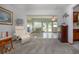 Cozy living room with plush recliner, neutral carpet, and sunroom view at 624 La Jolla Ave, Sun City Center, FL 33573