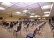A large meeting room with rows of chairs and elegant chandeliers overhead at 624 La Jolla Ave, Sun City Center, FL 33573
