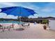 Resort-style pool area with umbrella-covered tables and lounge chairs, perfect for relaxation at 624 La Jolla Ave, Sun City Center, FL 33573