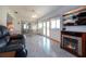 Bright sunroom with a fireplace, modern floors, and access to an outdoor view at 624 La Jolla Ave, Sun City Center, FL 33573