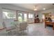 Bright sunroom featuring a glass table, comfortable seating, and outdoor views at 624 La Jolla Ave, Sun City Center, FL 33573