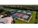 Community tennis courts, featuring multiple green and red courts, with golf carts parked nearby at 624 La Jolla Ave, Sun City Center, FL 33573