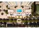 Aerial view of a building featuring a rooftop pool and manicured grounds and landscaping at 628 Cleveland St # 711, Clearwater, FL 33755