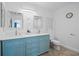 Bright bathroom featuring double sinks, elegant mirrors, and stylish blue cabinetry at 628 Cleveland St # 711, Clearwater, FL 33755
