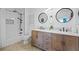 Bathroom featuring a wood vanity with double sinks, modern fixtures, and a shower with a tub at 628 Cleveland St # 711, Clearwater, FL 33755