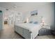 Bright bedroom with a large bed, beach-themed artwork, and a white dresser at 628 Cleveland St # 711, Clearwater, FL 33755
