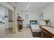 Bedroom with bed, desk, view to bathroom and hallway at 628 Cleveland St # 711, Clearwater, FL 33755