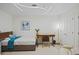 Cozy bedroom with a pull-out bed, desk, modern light fixture, and neutral decor at 628 Cleveland St # 711, Clearwater, FL 33755