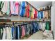 Well-organized walk-in closet featuring hanging racks for clothing and a patterned ottoman at 628 Cleveland St # 711, Clearwater, FL 33755