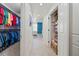 Hallway featuring closet space and leads to a serene bedroom with natural light and blue accents at 628 Cleveland St # 711, Clearwater, FL 33755