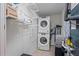 Efficient laundry area with stacked washer and dryer, shelving and utility connections at 628 Cleveland St # 711, Clearwater, FL 33755