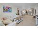 Bright open-concept living room featuring modern decor and a view to the kitchen at 628 Cleveland St # 711, Clearwater, FL 33755
