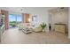 Bright living room featuring modern decor, plush seating, and a sliding glass door to a balcony at 628 Cleveland St # 711, Clearwater, FL 33755