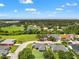 Aerial view of neighborhood featuring lush greenery, pond, and well-maintained homes at 6324 35Th Avenue E Cir, Palmetto, FL 34221