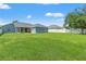 Large backyard enclosed by a white fence, offering ample space and privacy at 6324 35Th Avenue E Cir, Palmetto, FL 34221