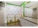 Well-lit bathroom with shower, decorative shower curtain and vanity with ample counter space at 6324 35Th Avenue E Cir, Palmetto, FL 34221