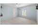Cozy bedroom with neutral carpet, blue walls, and a bright window at 6324 35Th Avenue E Cir, Palmetto, FL 34221