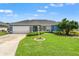 Charming single-story home with a lush green lawn, manicured landscaping, and a welcoming two-car garage at 6324 35Th Avenue E Cir, Palmetto, FL 34221